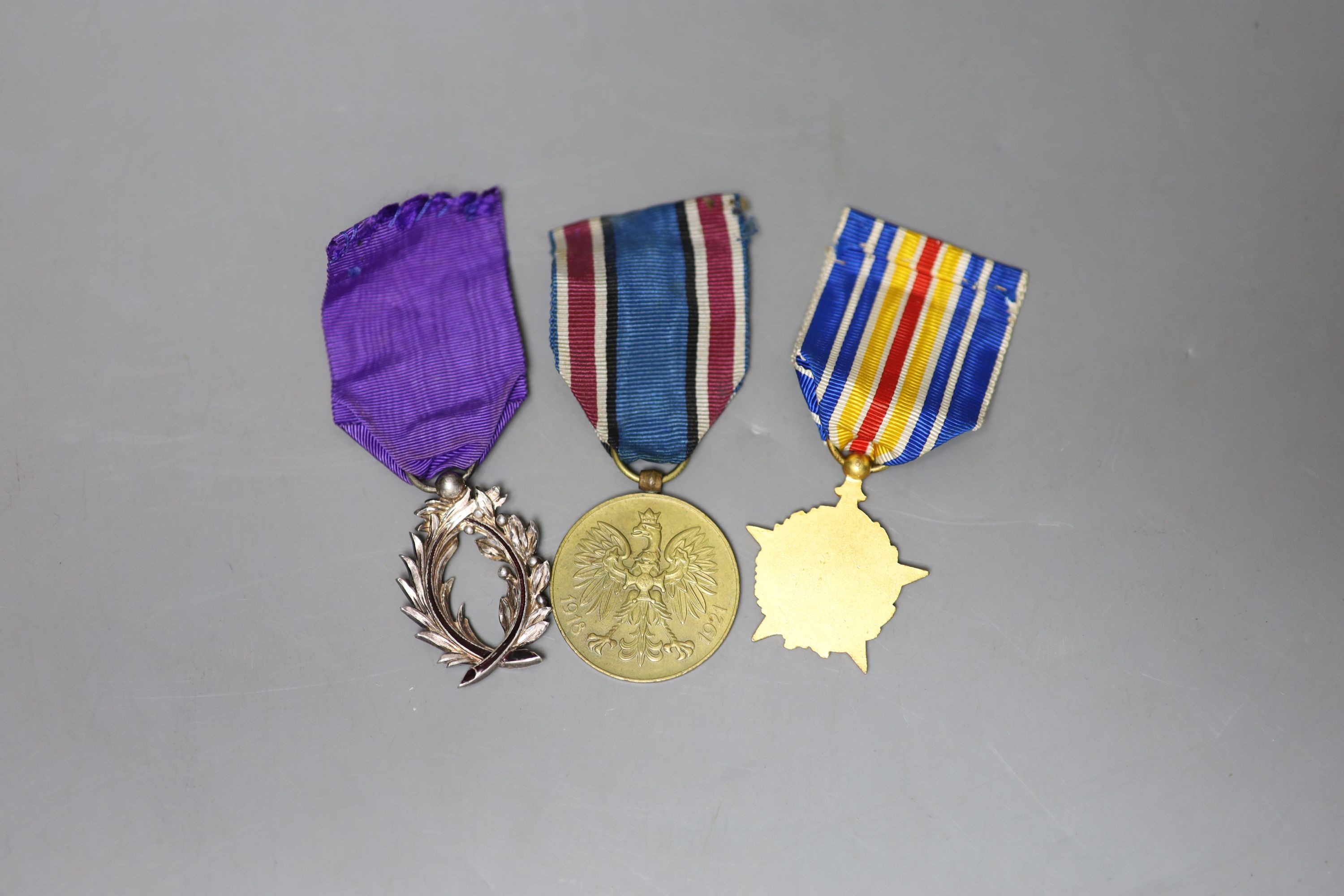 Three medals, including a Polish commemorative war medal (1918-1921), a Franco-Canadian Order of Academic Palms and a star medal